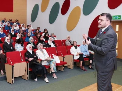 Dr. Nizar Baidoun speaking to Kuwait Oil Company staff in a full auditorium
